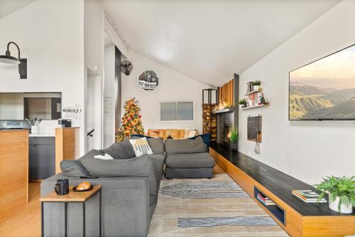 a living room with a couch and a table at Modern Treetop Cabin by Lake Arrowhead Village in Lake Arrowhead