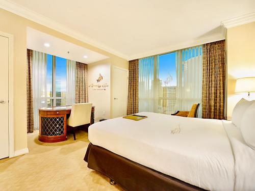 a hotel room with a large bed and a desk at Amalz Two Bedroom Three Bathroom Balcony Suites at Mgm Signature ! in Las Vegas