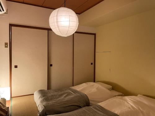 a bedroom with a bed and a light fixture at Sun Mall Crest 202 - Vacation STAY 15094 in Tokyo