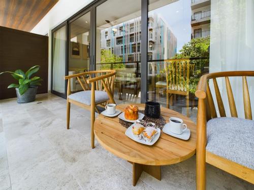 a table with food on it on a balcony at IPANA Luxury Apartments by Vacaciones.Yeah in Playa del Carmen