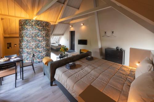 a bedroom with a large bed and a living room at Landelijke boerderijkamer, dichtbij Kinderdijk in Oud-Alblas