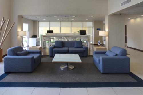 a lobby with two blue couches and a table at City Express by Marriott Xalapa in Xalapa