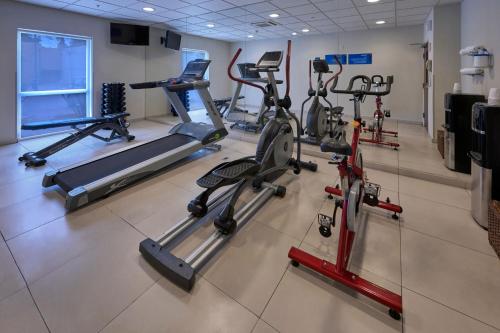 a gym with several tread machines in a room at City Express by Marriott Xalapa in Xalapa