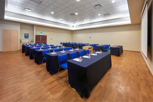 a conference room with blue tables and blue chairs at City Express by Marriott Xalapa in Xalapa