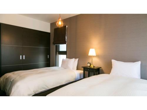 two beds sitting next to each other in a room at Kyoto Four Sisters Residence - Vacation STAY 15222v in Kyoto