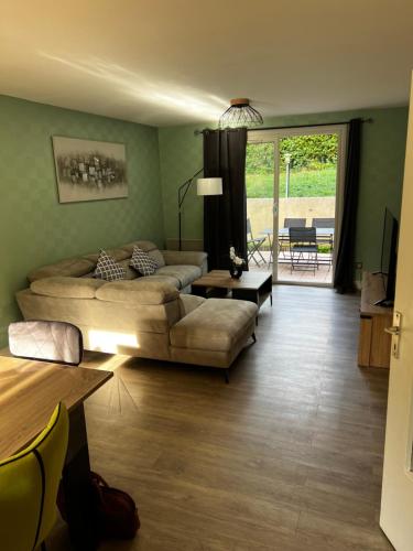 a living room with a bed and a couch at Belle maison familiale proche du lac in Bourges