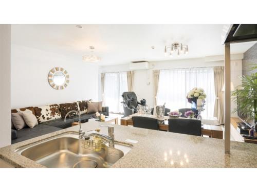 a kitchen and living room with a sink at Kyoto Four Sisters Residence - Vacation STAY 15185v in Kyoto