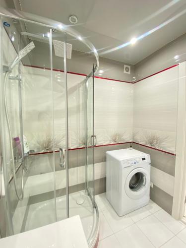 a bathroom with a washing machine and a shower at RentNow Family Large Apartament near Airport in Chişinău