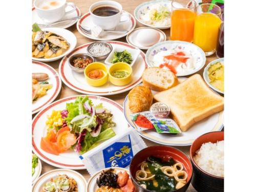 a table filled with plates of food and drinks at Hotel Terrace The Square Hitachi - Vacation STAY 16979v in Hitachi