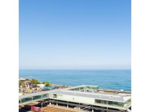 a view of a building with the ocean in the background at Hotel Terrace The Square Hitachi - Vacation STAY 16979v in Hitachi