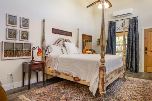 a bedroom with a canopy bed and a window at Inn at Sunset Mill Ranch in Wimberley