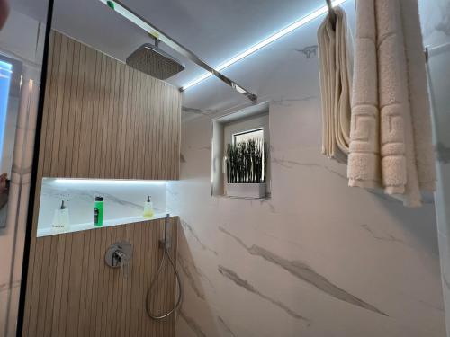 a bathroom with a sink and a mirror at Luxury Apartment Centrul Vechi in Curtea de Argeş