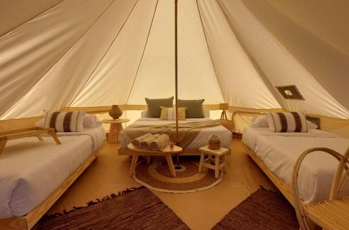 a bedroom with two beds in a tent at Terranova Glamping in Luján