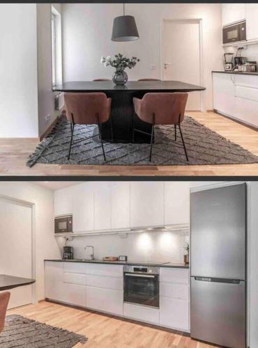 una cocina con armarios blancos y una mesa con sillas. en Central apartment Uppsala, en Uppsala