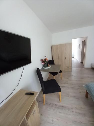 a living room with a flat screen tv on a wall at Spí v Kuklenách in Hradec Králové