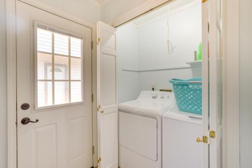 eine weiße Küche mit einem Waschbecken und einem Fenster in der Unterkunft Remote Greensboro Vacation Rental with Game Room! 