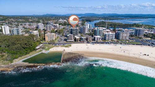 an aerial view of a beach with a large hot air balloon at The Strand 303 in Forster
