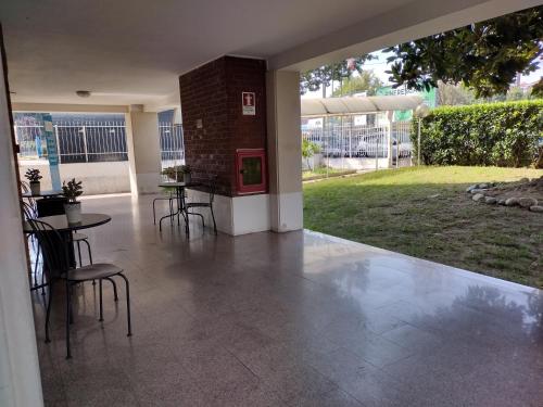 a patio with a table and chairs and a red machine at Albergo Guido Reni in Turin