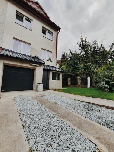 a driveway leading to a house with a garage at Willa Tradycja 2 in Gdańsk