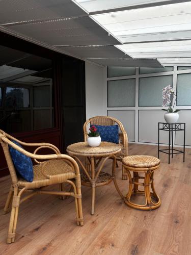 a room with two chairs and a table and a stool at Nord Haus in Kiel