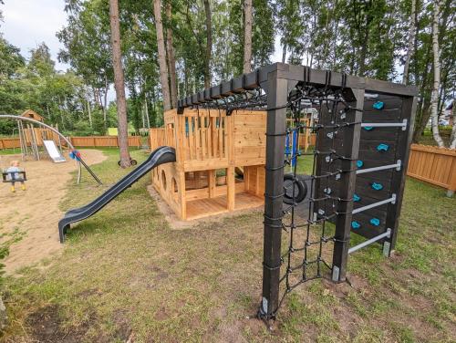 a playground with a climbing frame and a slide at Błękitna Dębki in Dębki