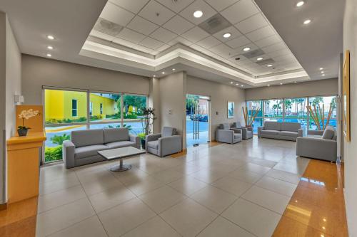 a lobby with couches and tables in a building at City Express by Marriott Monterrey Aeropuerto in Monterrey