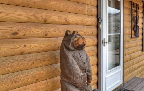 a statue of a bear on the side of a house at Warrick Cabin in Creede