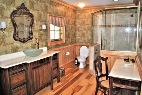 a bathroom with a sink and a toilet and a mirror at Good Wood 3BR Walking distance to restaurants and shops along the waterfront of Winyah Bay in Georgetown