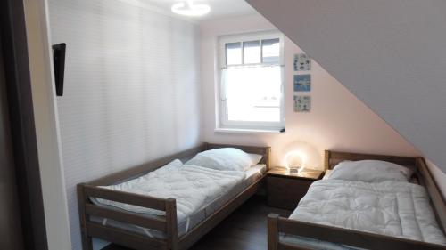 Postel nebo postele na pokoji v ubytování Ferienhaus Segelboot Hirtenweg 3c
