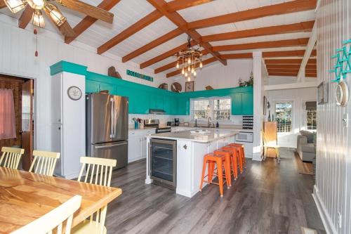 a kitchen with blue walls and a table and chairs at 5BR Scenic View 3 Minutes to the Beach in Pawleys Island