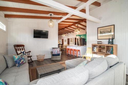 a living room with a couch and a kitchen at 5BR Scenic View 3 Minutes to the Beach in Pawleys Island
