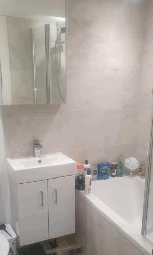 a white bathroom with a sink and a shower at 10 Street in Wareham