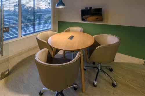 a conference room with a table and chairs at City Express Plus by Marriott Bogota Aeropuerto in Bogotá
