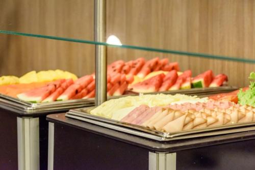 a buffet of different types of meats and vegetables at City Express Plus by Marriott Bogota Aeropuerto in Bogotá