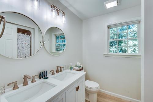 a white bathroom with a sink and two mirrors at Lake Hartwell Retreat with 2-Tier Dock and Boat Slip! in Seneca