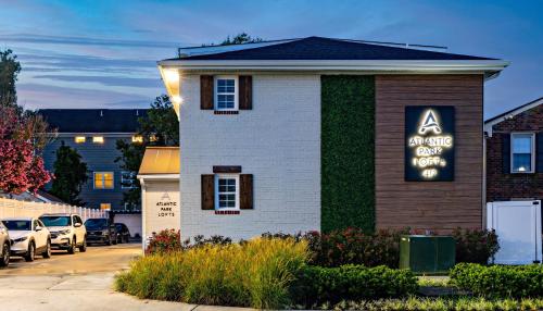 a house with a sign on the side of it at Ocean Lofts in the Vibe #4 - 5 min walk to beach in Virginia Beach