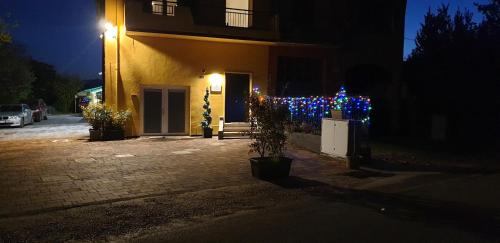 a house with christmas lights on the side of it at casadelfalegname ABETE in San Giovanni in Bosco
