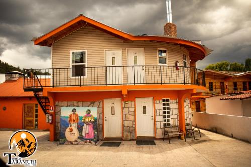 a house with a mural on the side of it at TARAMURI HOTEL & TOURS in Creel