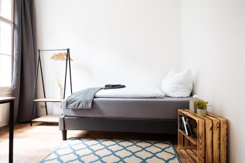 a bedroom with a bed with a blue rug at Apartments an der Oper - Innenstadt - Zentral - Küche - Wifi - Powered by Ko-Living in Halle an der Saale