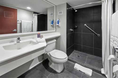 a bathroom with a sink and a toilet and a shower at City Express by Marriott San Luis Potosi Zona Universitaria in San Luis Potosí