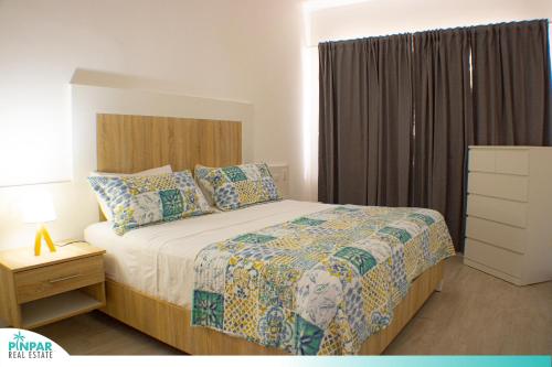 a bedroom with a large bed and a window at Deluxe Condo/1BR-1BT/Close to Beach/Pool View in Punta Cana