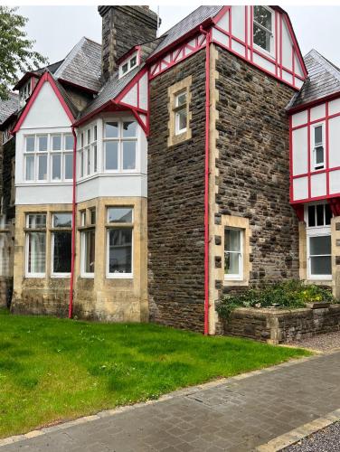 a large brick house with red trim at Sophia's Cwtch in Cardiff