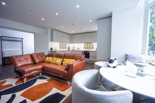 a living room with a couch and a table at Sophia's Cwtch in Cardiff