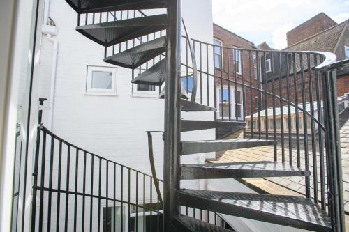 a spiral staircase leading up to a building at Superb City Center 2 Bed Apartment Free Wifi in Lincoln
