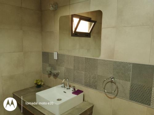 a bathroom with a sink and a mirror at Mágico Atardecer Cabaña in Tunuyán