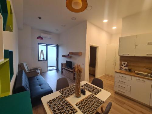 a kitchen and living room with a table and a couch at Luxury Central Apartment One in Bacău