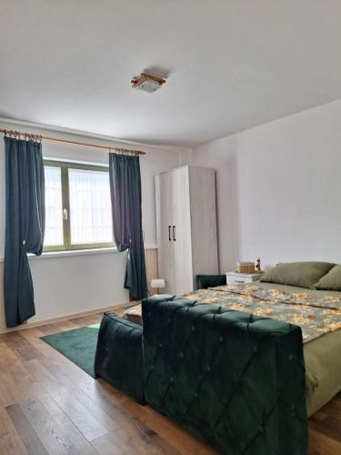 a bedroom with a large bed and a couch at Bajka in Valjevo
