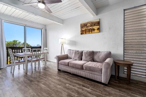 a living room with a couch and a table at Kona Mansions#105 in Kailua-Kona