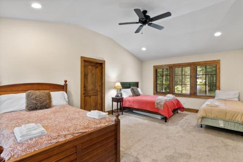 a bedroom with two beds and a ceiling fan at Find The Joy in Blowing Rock