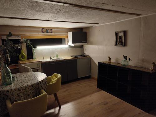 a kitchen with a table and a counter top at Mobilhomes vintage dans ecolieux en cours camping a la ferme in Ponteilla